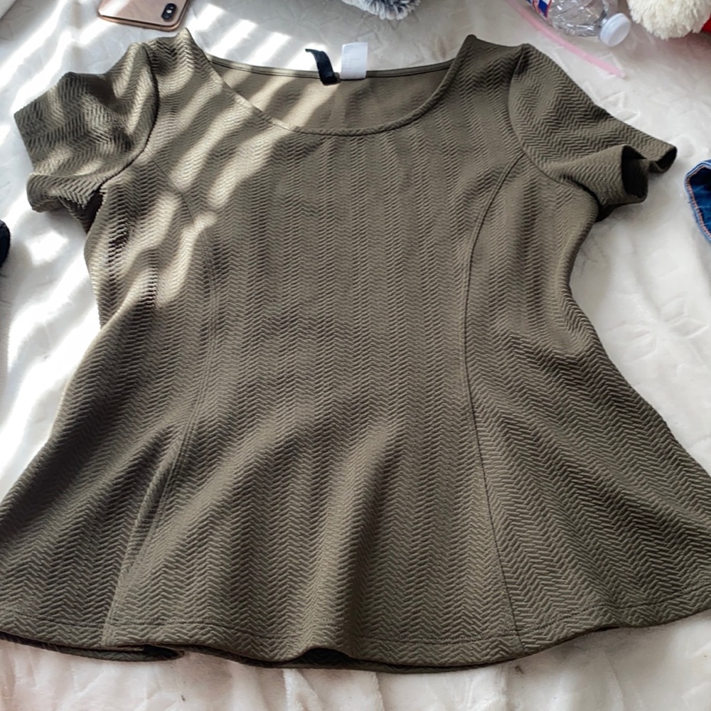a dark greenish shirt that has never been worn